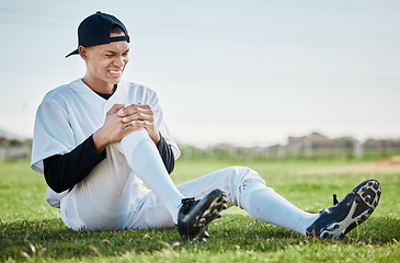 Image showing Baseball, pain and man with knee injury on field after accident, fall or workout in match. Sports, training and male athlete with fibromyalgia, inflammation or broken leg, arthritis or tendinitis.