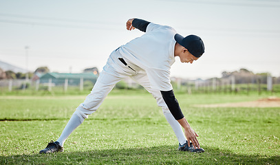 Image showing Baseball stadium, stretching legs or man on field ready for training match on grass in summer. Healthy athlete, fitness workout or young sports player warm up to start softball exercise outdoors