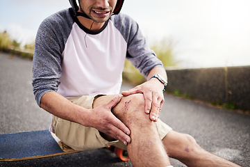 Image showing Injury, man and knee pain after skateboarding accident, practice and learning to skate. Active, bad and skateboarder with a bruise, broken bone or holding a painful leg in the street while skating