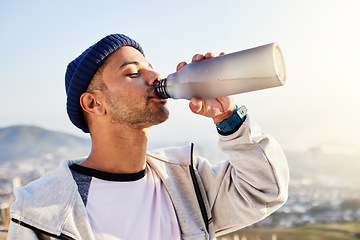 Image showing Man drinking water, runner in city with fitness and health, thirsty and hygiene with satisfaction and break from running outdoor. Bottle, h2o and eyes closed with young male, urban and exercise