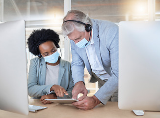 Image showing Covid, crm and employees with tablet, mask and senior man helping black woman at call center help desk. Compliance, consulting and opinion, crm data for medical advisory agency with coaching support.