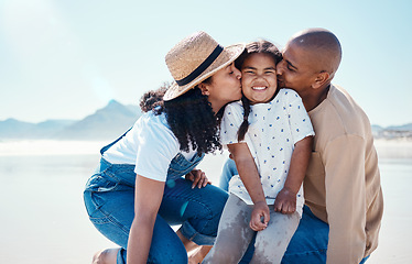 Image showing Black family, children and beach with parents kissing their daughter outdoor in nature on the sand by the ocean. Kids, love or summer with a mother and father giving a kiss to their female child