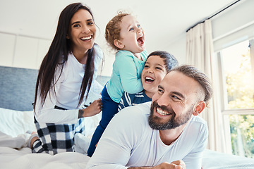 Image showing Family, portrait and laughing on bed in house, having fun and bonding together. Comic, love and care of happy father, mother and kids or boys playing, smile and enjoying quality time in home bedroom.