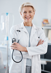 Image showing Portrait, woman and doctor with arms crossed, stethoscope and happiness in hospital, clinic and surgery. Mature female medical worker smile for healthcare services, cardiology wellness and experience