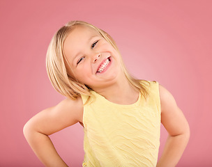 Image showing Smile, cute and portrait of a posing child isolated on a pink background in a studio. Happy, adorable and an excited young girl with happiness, smiling and excitement with a pose on a backdrop