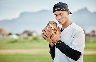 Image showing Portrait pitcher, baseball player or man training for a sports game on outdoor field stadium. Fitness, motivation or focused athlete pitching or throwing a ball with a glove in workout or exercise