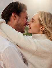 Image showing Love, smile and kiss with couple in nature for romance, bonding and affectionate together. Sensual, happiness and embrace with man and woman hugging on date for sunset, anniversary and summer break