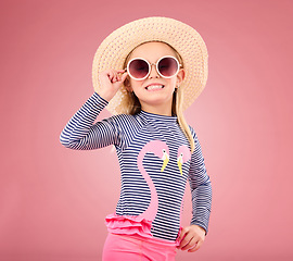 Image showing Vacation, portrait of happy child with sunglasses and hat in studio with fun clothes isolated on pink background. Summer, holiday and fashion, girl in Australia excited for travel with smile on face.