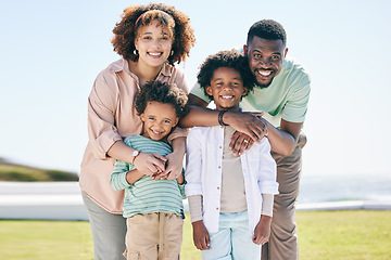 Image showing Love, happy and portrait of a family at the beach on a summer vacation, adventure or weekend trip. Happiness, smile and parents posing and bonding with boy children by the ocean while on holiday.