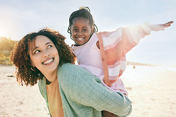 Image showing Portrait, fly or girl with mother at beach on summer holiday vacation together as a happy family. Fun African mom, piggyback or excited young child love bonding, relaxing or playing in nature or sea