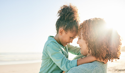 Image showing Family, mother and kid hug at beach, travel and summer with sunshine lens flare and together outdoor. Trust, support with woman and girl smile on vacation, love and care in nature with happiness