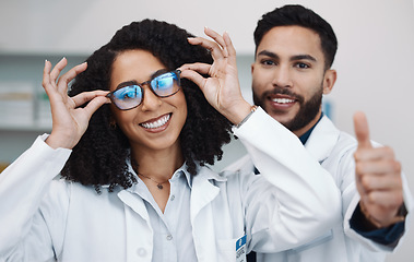 Image showing Vision portrait, doctor thumbs up and smile of a female healthcare worker in a hospital. Agreement, glasses choice and happy woman looking at lens and frames options in a optometrist clinic