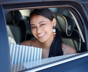 Image showing Shopping, happy and portrait of a woman in a cab for transportation after retail in the city. Smile, happiness and a girl with bags from fashion, store or boutique in a taxi car for transport