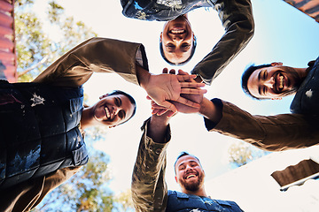 Image showing Portrait, team motivation or hands in huddle for goals, hope or soldier training on war battlefield. Mission, low angle or happy army friends in solidarity and support in paintball or military group