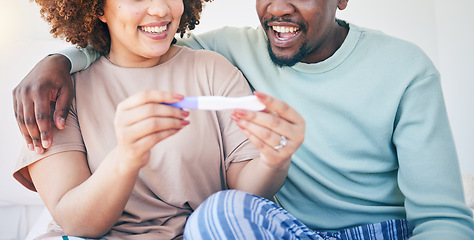 Image showing Couple, happy and pregnancy test, smile and excited for good news, positive and results in their house. Hands, woman and man with home testing kit, pregnant and fertility or ivf success while hugging