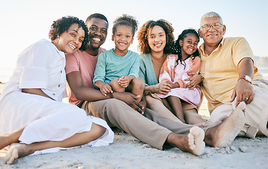 Image showing Family at beach, portrait and generations, happy people relax outdoor with grandparents, parents and kids. Happiness, smile and sitting together on sand, travel and vacation with love and bond