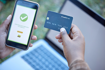 Image showing Credit card, phone banking app and approval check on a mobile website payment with laptop mockup. Online shopping, ecommerce and 5g connectivity of a customer doing a internet sale outdoor on grass