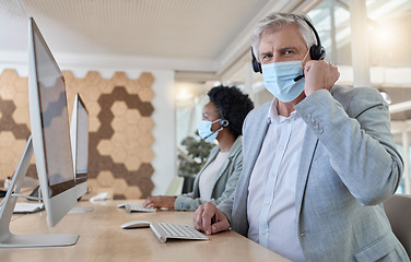 Image showing Covid, portrait and man in a call center for service, online help and advice on a computer. Talking, telemarketing and mature customer support employee wearing a face mask while consulting on a pc