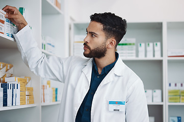 Image showing Pharmacy, medical and shelf with man in store for healthcare, drugs dispensary and treatment prescription. Medicine, pills and shopping with pharmacist for check, label information and product