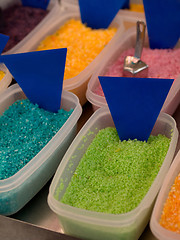 Image showing plastic boxes filled with colored sweets powder