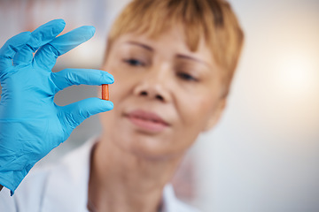 Image showing Pharmacist, pharmacy and hands of woman with pills, medication or antibiotics in drugstore. Healthcare, wellness and medical doctor look, check or quality inspection of drugs, medicine or supplements