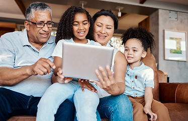 Image showing Family, relax and girl with tablet on sofa in home living room for social media or funny video streaming. Technology, care and happy grandfather, grandma and kids laughing or bonding with touchscreen