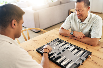 Image showing Senior, man and play backgammon in home with focus, strategy and contest for thinking, moving or son by table. Elderly man, board game competition and relax with bonding, love and family house lounge