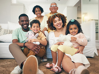 Image showing Happy, interracial and portrait of a big family bonding, smiling and playing during a visit. Smile, quality time and parents, grandparents and children sitting in a living room for happiness at home