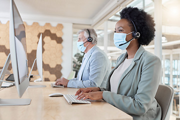 Image showing Covid, masks and call center agents in compliance working as a team on customer service in an office typing. Computer, Consultant and telemarketing colleagues in a company doing technical support