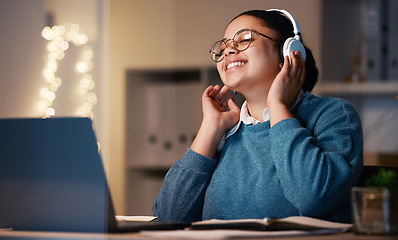 Image showing Music headphones, student and woman in home at night streaming radio or podcast after elearning. Freelancer, remote worker or happy business female listening or enjoying audio, song or album in house