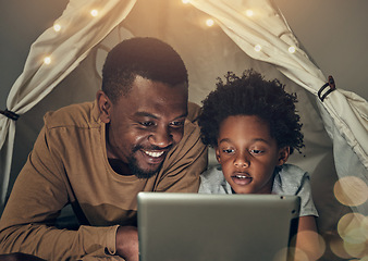 Image showing Black family, tablet and father with kid in tent at night watching movie, video and having fun in home. Technology, bokeh and smile of happy dad bonding with boy child while streaming film in house.