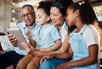 Image showing Relax, family tablet and grandparents with girls on sofa in home living room for social media or video streaming. Technology, care and happy grandfather, grandma and kids bonding with touchscreen.