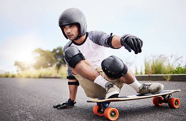 Image showing Skateboard slide, action and man in road for sports competition, training and balance in city. Skating, skateboarding hobby and male skater in gear riding for speed, adventure and race adrenaline