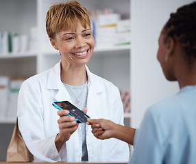 Image showing Pharmacy, pharmacist and credit card payment of customer for medication, medicine or product in store. Senior healthcare, fintech smile and happy woman shopping for medical drugs with pos machine.