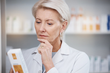 Image showing Pharmacist, pharmacy and woman reading medicine label, pills or box in drugstore. Healthcare, thinking and elderly medical doctor looking at medication, antibiotics or drugs, vitamins or supplements.