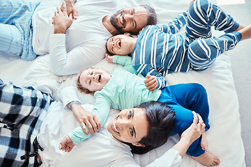 Image showing Morning, laugh and happy with family in bedroom for wakeup, affectionate and bonding from top view. Smile, care and funny with parents and children in bed at home for playful, happiness and support