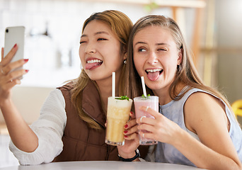 Image showing Selfie, wink or funny friends take profile picture in cafe with happy smile on holiday vacation or weekend. Crazy faces, Asian or young women smiling for social media posts brunch date with cocktails