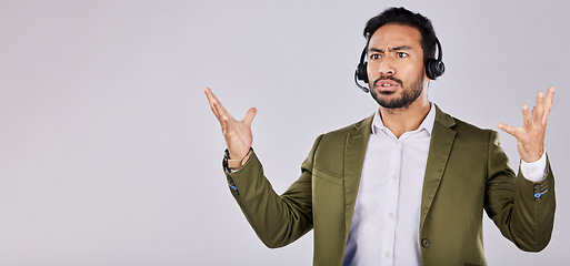 Image showing Confused, question and frustrated man call center agent angry isolated against a studio grey background and stress. Employee, ask and rude customer service worker or consultant annoyed at work