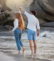 Image showing Love, dance and happy with couple at beach for romance, relax and vacation trip. Travel, sweet and cute relationship with man and woman holding hands on date for summer break, trust and bonding