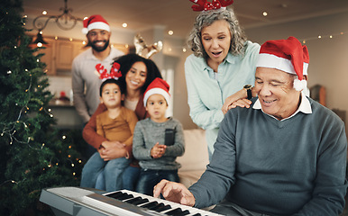 Image showing Family, christmas and senior man with piano in a living room for celebration, song and bond in their home. Music, instrument and retired pianist performing for kids and parents in festive celebration