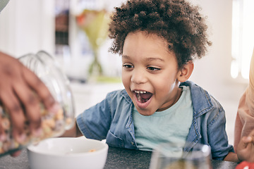 Image showing Excited, happy and child ready for breakfast cereal in the morning feeling hungry for cornflakes in a home or house. Kid, food and young boy in the kitchen smile due to meal sitting at table