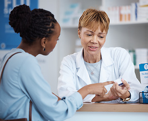 Image showing Healthcare, label information and black woman with pharmacist at counter for advice on safe prescription drugs. Health, pharmaceutical info and patient consulting medical professional at pharmacy.