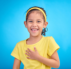 Image showing Child laugh, happy portrait and smile of a little girl in a studio with blue background feeling cute. Happiness, adorable and face of a confident, playful and fun kid laughing about a funny joke