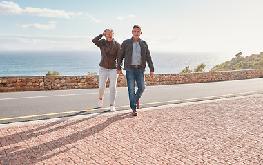 Image showing Travel, road and senior couple walking enjoy holiday, adventure and vacation holding hands on mountain. Retirement, love and happy old man and woman for bonding, quality time and relax together