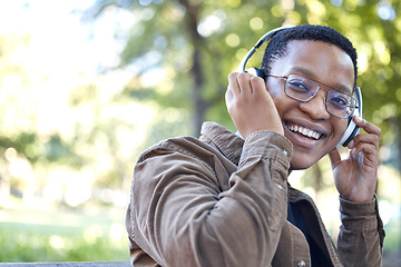 Image showing Headphones, park and portrait of african man listening to music for outdoor, mental health and relaxing break in nature. Young, happy student or black person with audio technology in garden or campus