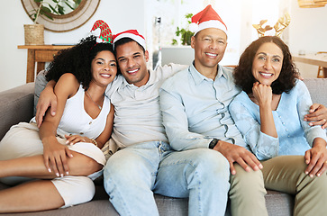 Image showing Christmas, happy family and people on holiday in a home celebrating on vacation and bonding in a house. Portrait, men and women on a couch or sofa in December for celebration together in living room