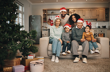 Image showing Christmas, big family and portrait smile in living room on sofa in home, bonding and care. Xmas, interracial and happy grandmother, grandfather and parents with kids or children enjoying holiday.