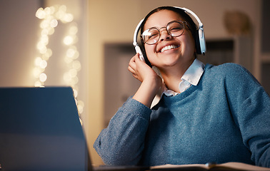 Image showing Student, music headphones and woman in home at night streaming radio or podcast after elearning. Freelancer, remote worker or happy business female listening or enjoying audio, song or album in house