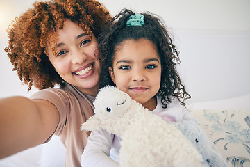 Image showing Mother, home and young girl selfie on a bed in the morning with toy in a family bedroom. House, smile and happy mom with a child taking a picture for social media with mama love and care for her kid