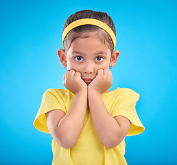 Image showing Mockup, portrait and girl nervous, scared and overwhelmed against a blue studio background. Face, female child and kid with anxiety, stress and worried with mental health, anxious and panic reaction